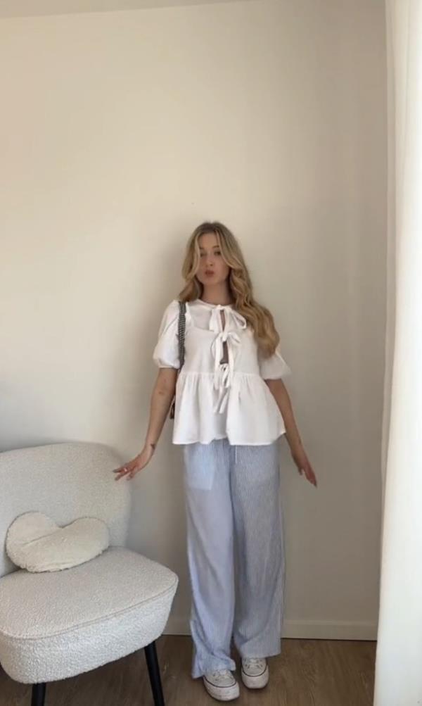 Swedish influencer Matilda Djerf, known for her polished, feminine style, dressed in stylish pajama pants in a room.